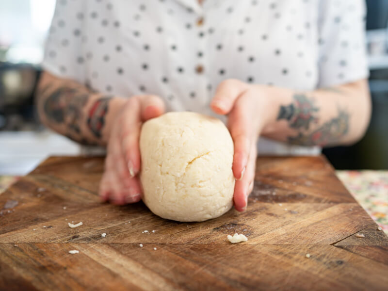 Close-up of someone holding dough between their hands